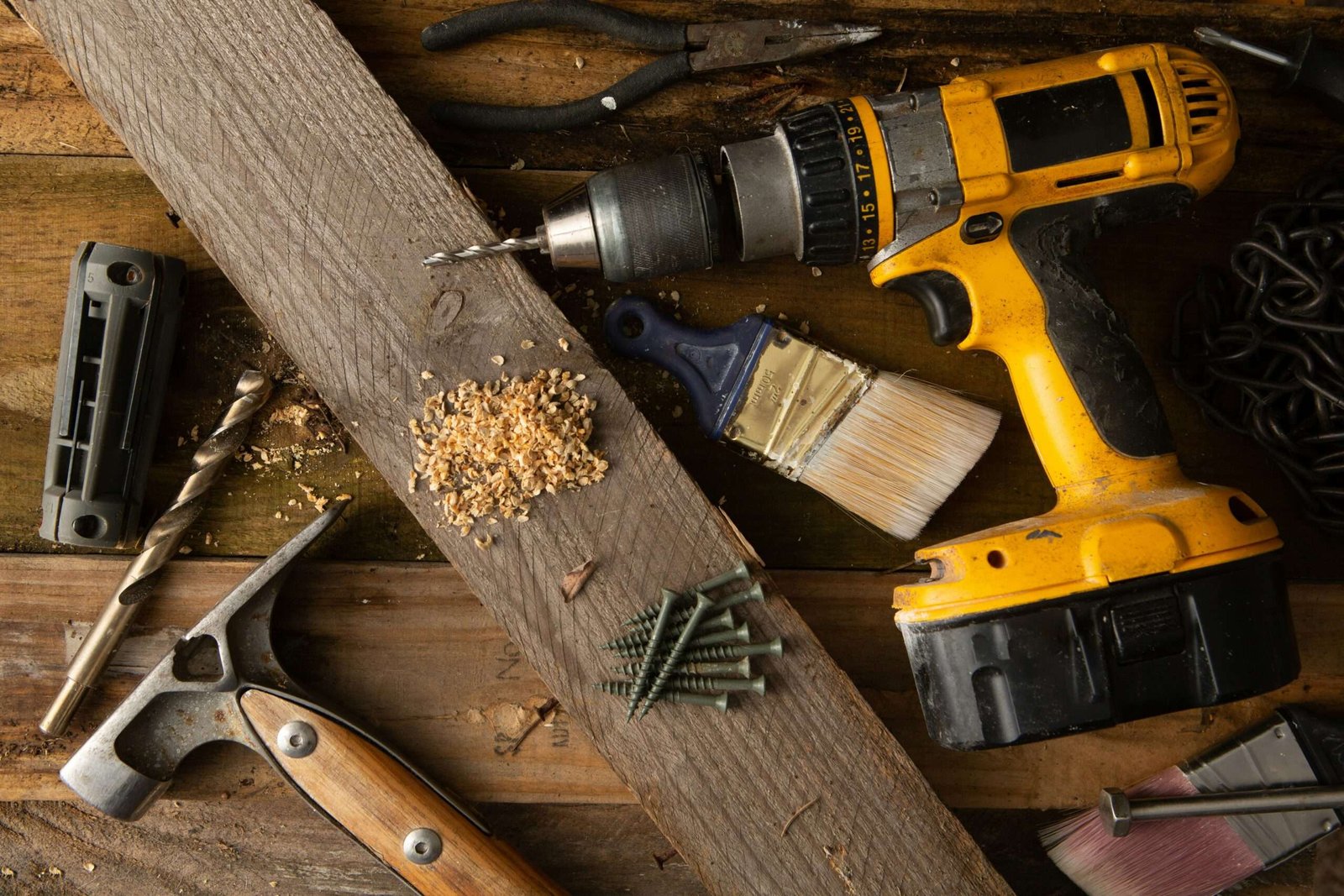 toolbox mistakes shown with drill, screws, hammer, and drill bits on a wooden workbench