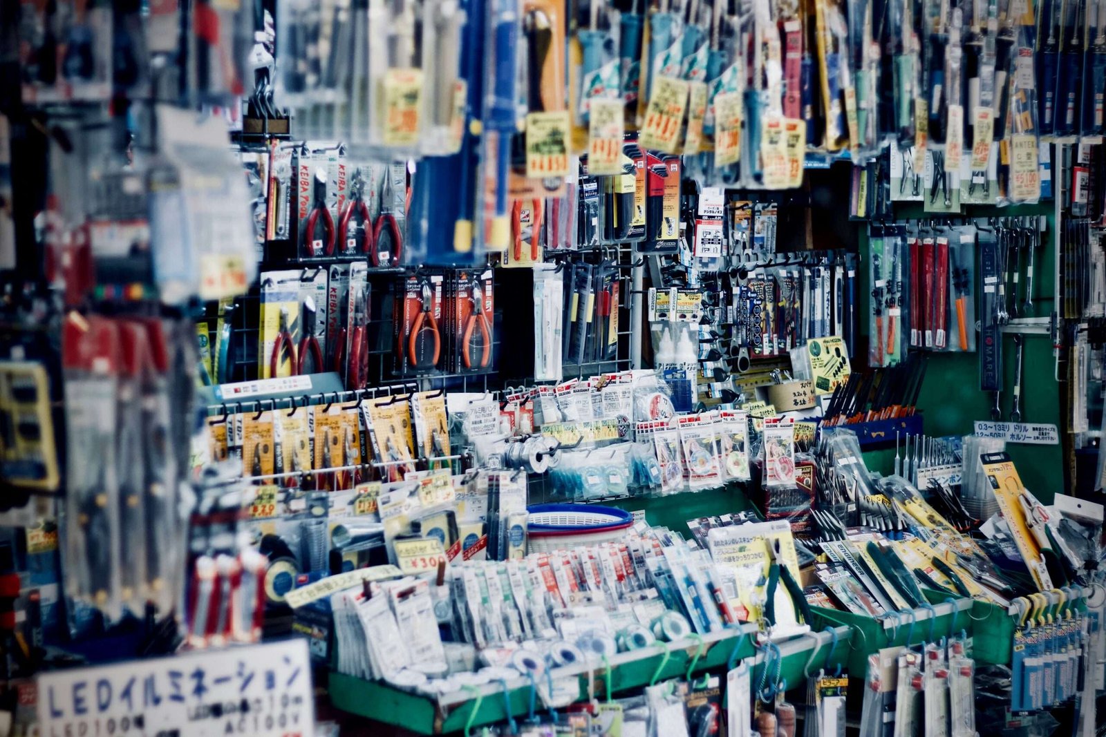 Essential hardware tools including hand tools, fasteners, and accessories displayed in a professional hardware supply store for construction and maintenance projects.